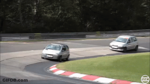Silver Car Driving On Road With Hedge Behind GIF