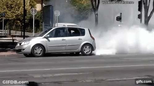 Silver Car Driving With Smoke From Tires GIF