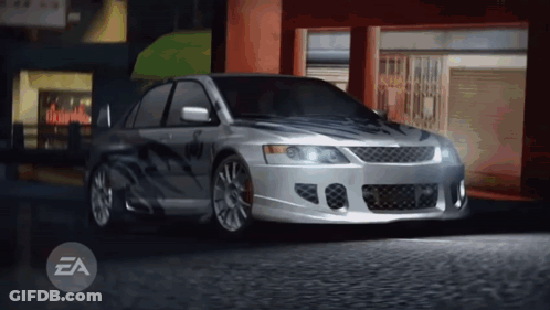 Silver Car Parked In Front Of Building With EA Letters GIF