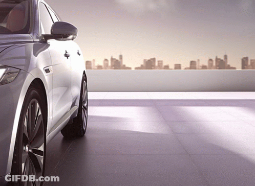 Silver Car Parked On Rooftop With City Skyline GIF
