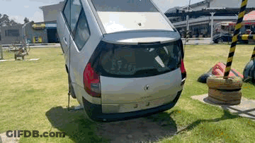 Silver Car Stuck In Park Grass GIF
