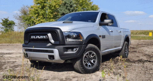 Silver Dodge Ram Truck Parked In Dirt Field GIF