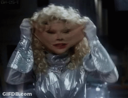 Silver Suit Woman Covering Face Making Funny Expression GIF
