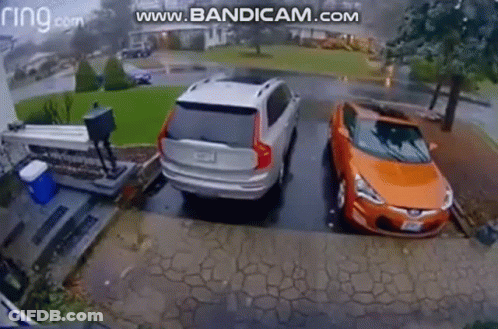 Silver SUV And Orange Car Parked In Driveway GIF
