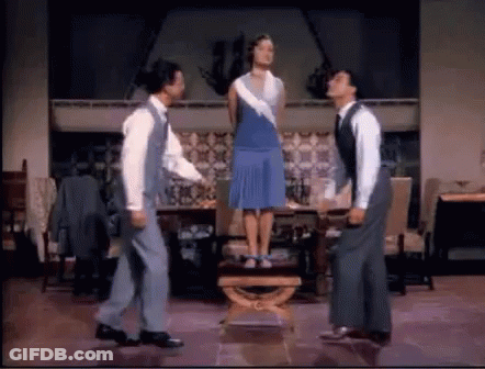 Singin' In The Rain Three People Holding Umbrellas GIF