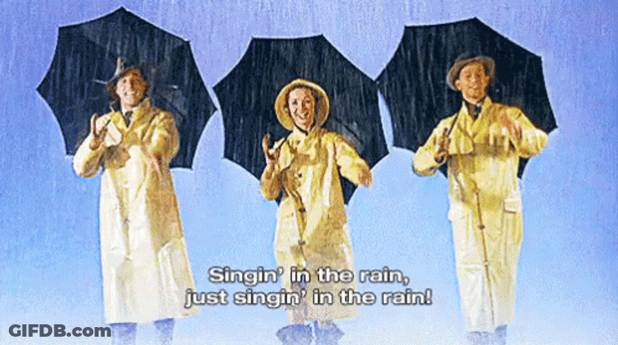 Singing In The Rain In Raincoats GIF