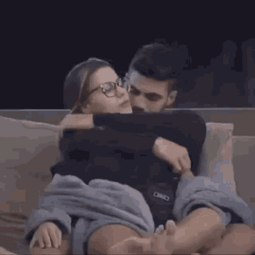 Sitting Couple Hugs And Kisses GIF