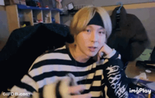 Sitting Man With Headband And Striped Sweater GIF