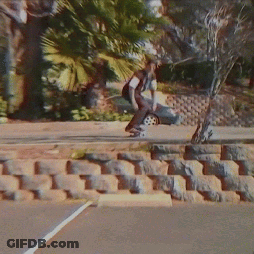 Skateboarder Doing Trick On Sidewalk GIF