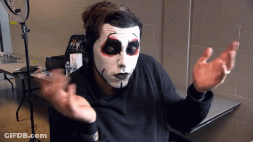 Skeleton Face Man Sitting At Table GIF