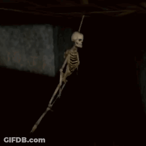 Skeleton Hanging From Ceiling In Dark Room Video Game GIF