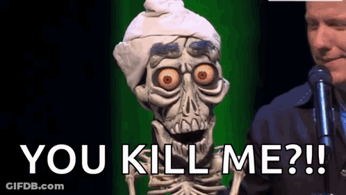 Skeleton Puppet Standing Next To Man With Microphone Saying You Kill Me GIF