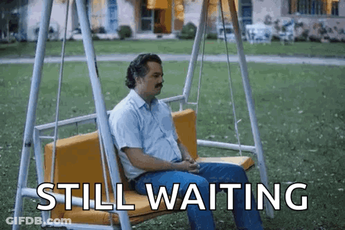 Skeleton Sitting At Table Saying Still Waiting GIF