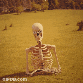 Skeleton Sitting In Grass Saying Well GIF