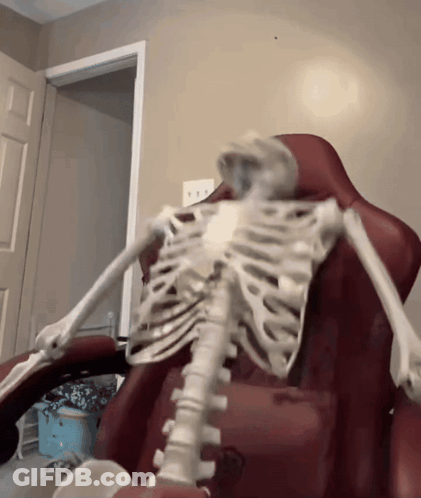 Skeleton Sitting In Red Chair GIF