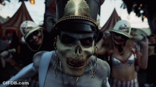 Skeleton Wearing Hat And Chains Surrounded By Skeletons GIF