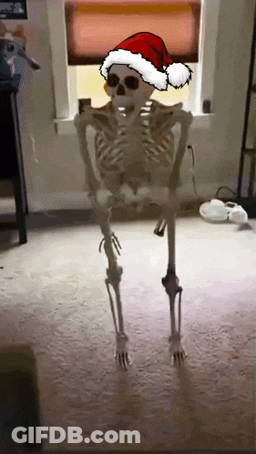 Skeleton Wearing Santa Hat Standing In Room GIF