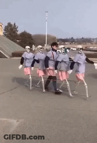 Skeletons Carrying Person On Stretcher GIF