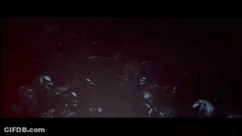 Skeletons In Dark Room With Arms Outstretched GIF