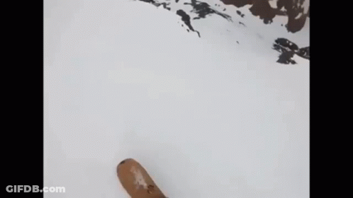 Skiing Down Snowy Slope In Green Jacket And Gloves GIF