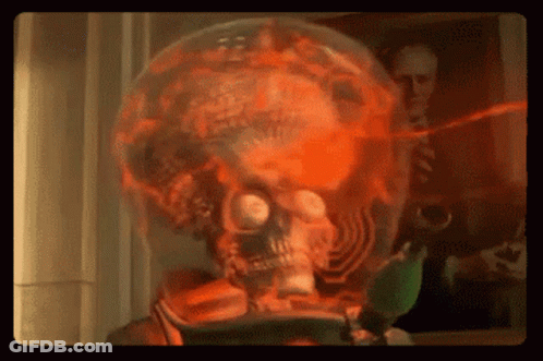 Skull In Glass Globe With Man Picture Behind GIF