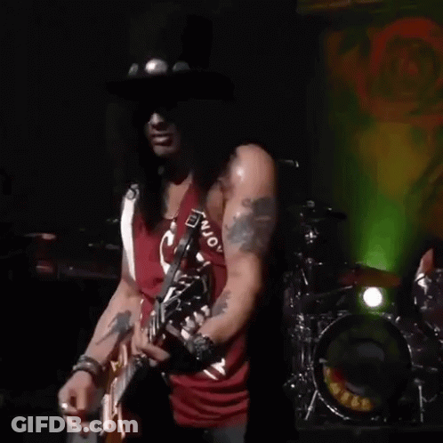 Slash Of Guns N ' Roses Is Playing A Guitar On Stage . GIF