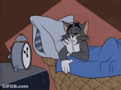 Sleeping Cartoon Cat Next To Alarm Clock GIF