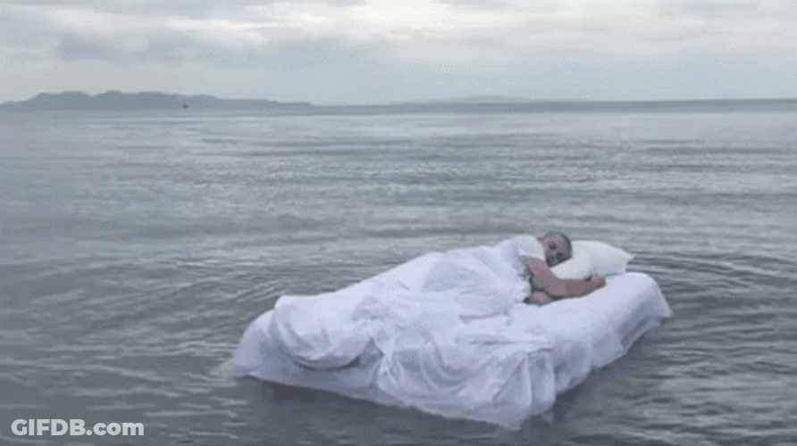 Sleeping Man Floating On The Ocean GIF