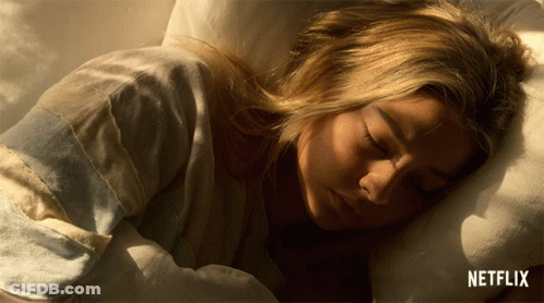 Sleeping Woman In Bed With Netflix Logo GIF
