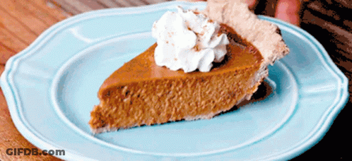 Slice Of Pumpkin Pie On Blue Plate With Whipped Cream GIF