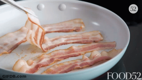 Slices Of Bacon Are Being Cooked In A Frying Pan With The Words Food52 On The Bottom GIF