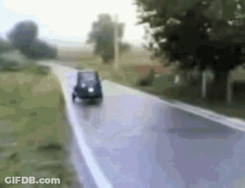 Small Car Driving Down Road GIF
