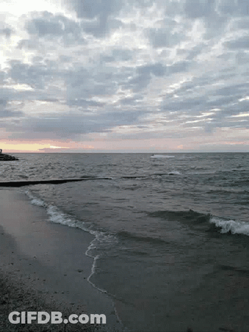 Small Ocean Waves Approaching Coastline GIF