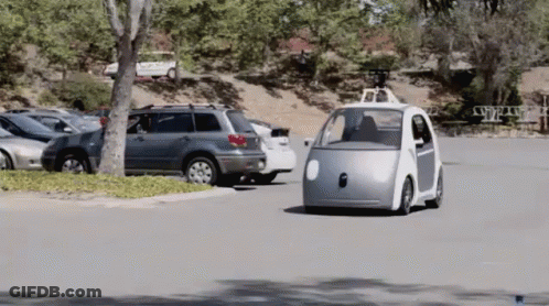 Small Silver Car Driving Down Road With Other Cars GIF