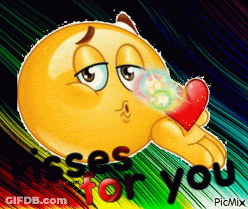 Smiley Blowing Kiss Holding Heart Saying Kisses For You GIF