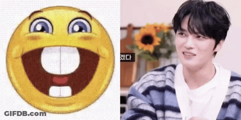 Smiley Face Next To Man In Striped Sweater GIF