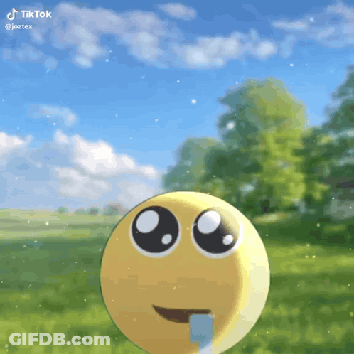 Smiley Face Sticking Tongue Out In Grass GIF