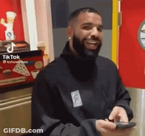 Smiling Bearded Man With Cell Phone In Restaurant GIF
