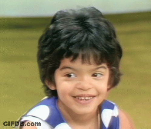 Smiling Boy In Blue White Polka Dot Shirt GIF