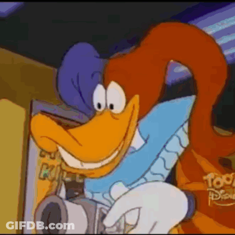 Smiling Cartoon Character Holding Camera At Disney Sign GIF