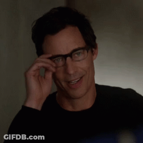 Smiling Man Adjusting Glasses In Black Shirt GIF