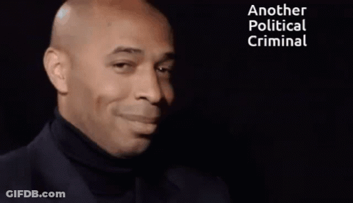 Smiling Man Black Turtleneck Saying Another Political Criminal GIF