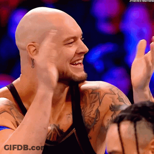 Smiling Man Clapping With Tattooed Arm GIF