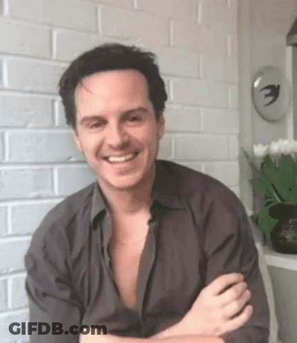 Smiling Man Crossed Arms Brick Wall GIF