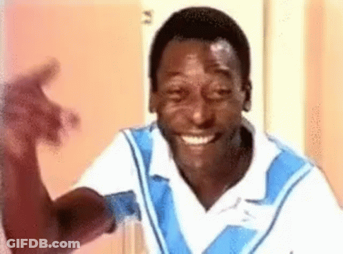 Smiling Man In Blue And White Shirt Waving GIF