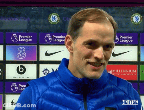 Smiling Man In Blue Jacket With Premier League Banner GIF