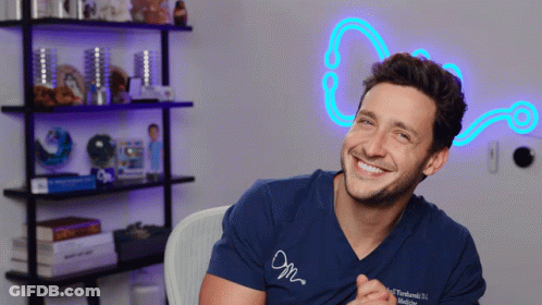 Smiling Man In Blue Shirt Saying M GIF