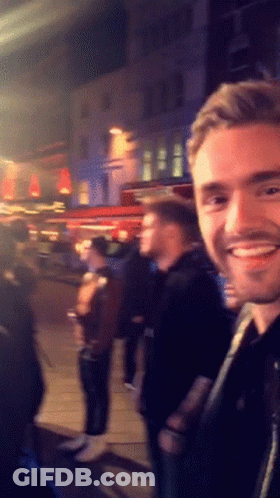 Smiling Man In Front Of Crowd GIF