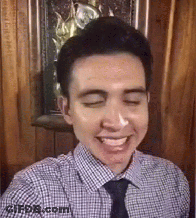 Smiling Man In Plaid Shirt And Tie Taking Selfie GIF