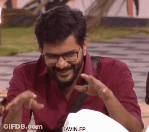 Smiling Man In Red Shirt And Glasses Pointing GIF